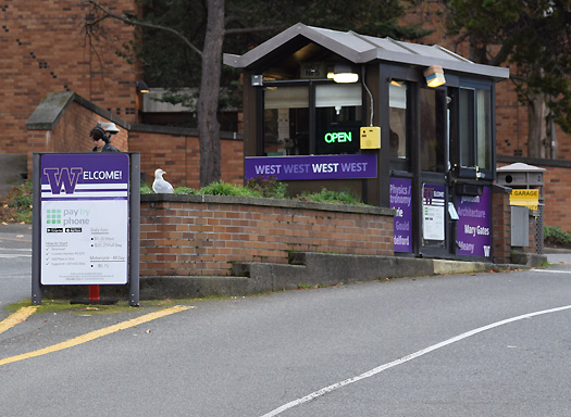 west campus gatehouse centered in roadway with open sign on