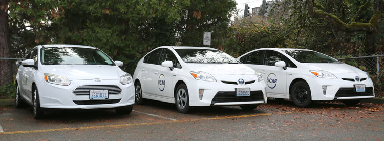 white fleet and ucar vehicles parked in a parking lot