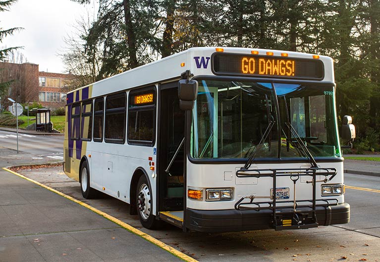 White Health Science Express shuttle bus with "Go Dawgs" written digitally on front