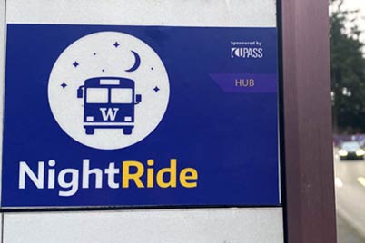 NightRide sticker on Metro bus stop indicating the Husky Union Building (HUB) stop