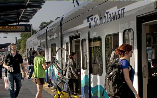 man walking next to light rail