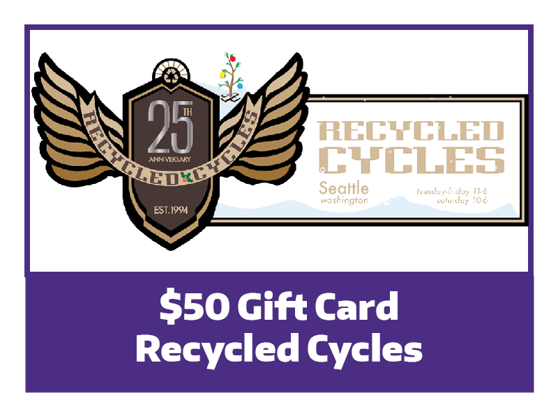 A purple box with an image of the Recycled Cycles logo; a shield that says 25th anniversary, and a ribbon draped from left to right across the wings that reads "Recycled Cycles"