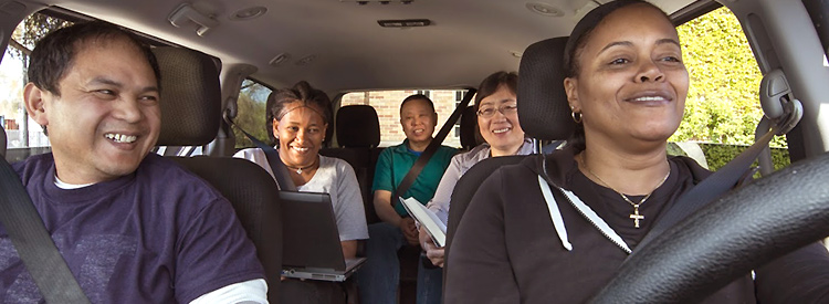 five employees riding in a vanpool smiling