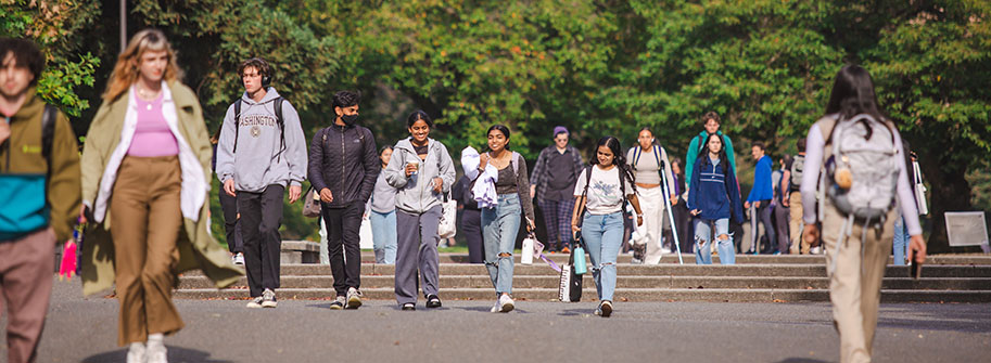 students walking, talking and smiling through the quad