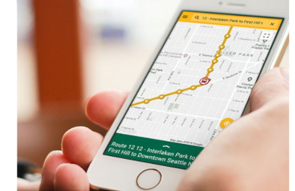 Hand holding smart phone device with trip planner application open
