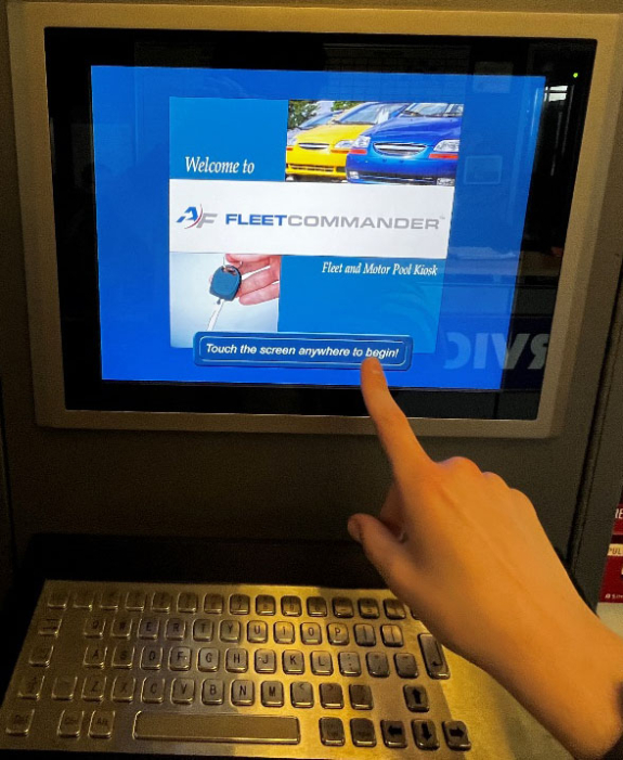 key manager kiosk screen showing start screen with a person's finger ready to touch the touch the screen anywhere to begin button