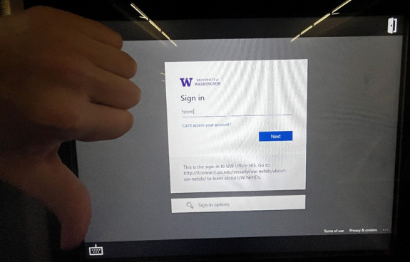 key manager kiosk screen showing only netid filled out at uw office 365 sign in screen and person's hand with a thumbs down