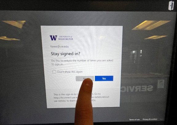 key manager kiosk screen showing stay signed in? language and person's finger about to tap no button