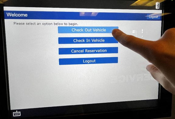 key manager kiosk screen shot showing check out vehicle button selected as person's finger taps that button on screen