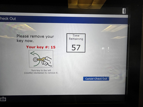 key manager kiosk screen showing your key is number 15 in red text and a timer with please remove your key now message