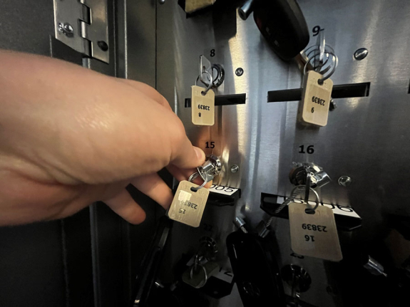 key manager box interior showing person's hand turning key at slot 15