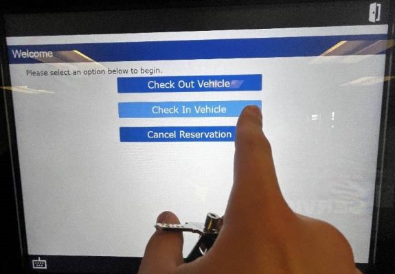 check in options displayed on touch screen with person's finger ready to tap check in vehicle option button