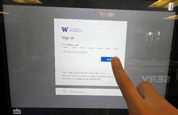 netid login screen with email address filled in with person's finger ready to tap next button