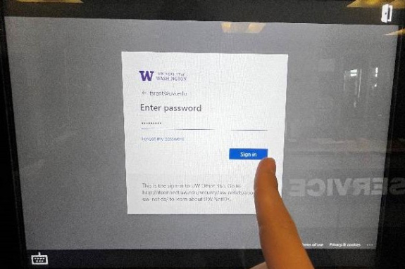 netid login screen with password filled in with person's finger ready to tap sign in button