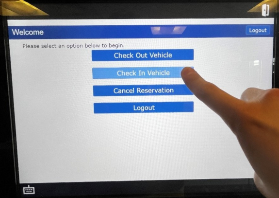 check in options displayed on touch screen with person's finger ready to tap check in vehicle option button