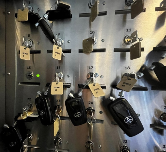interior of key manager box with numbered slots and keys shown and a green light next to empty slot number 15