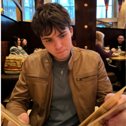 A photo of Jayce in a restaurant reading a menu