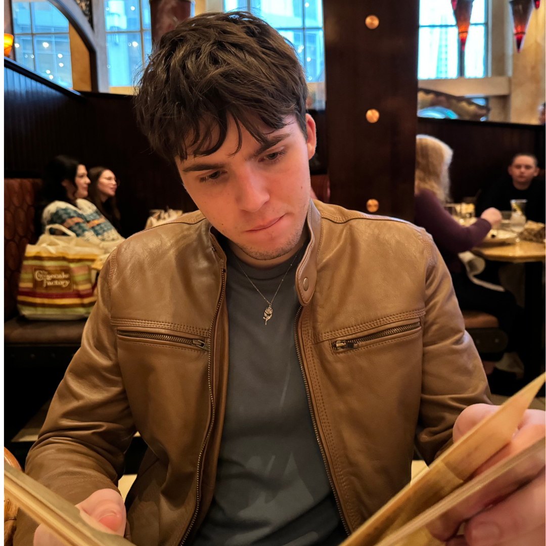 A photo of Jayce in a restaurant reading a menu