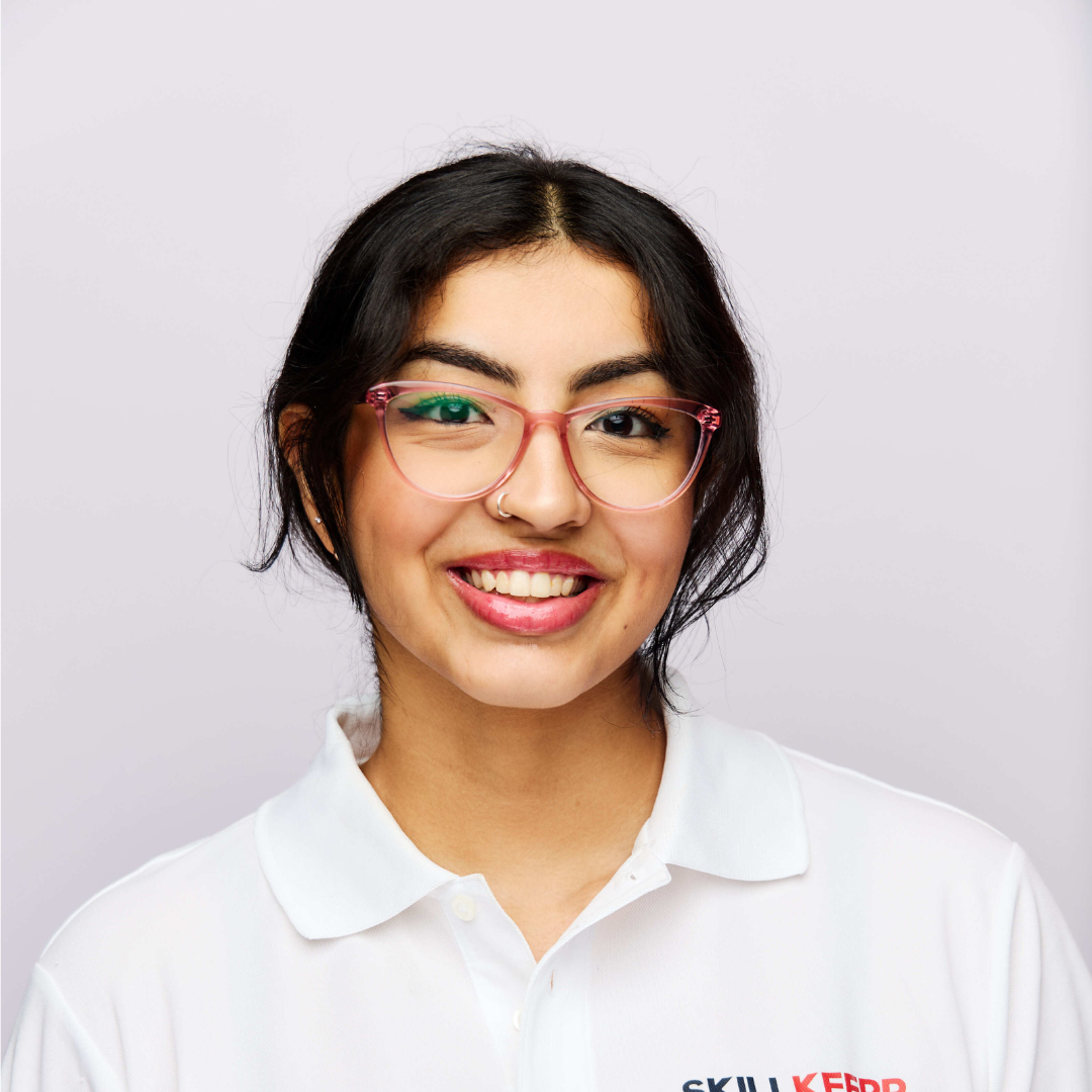 A photo of Kaira in front of a white backdrop
