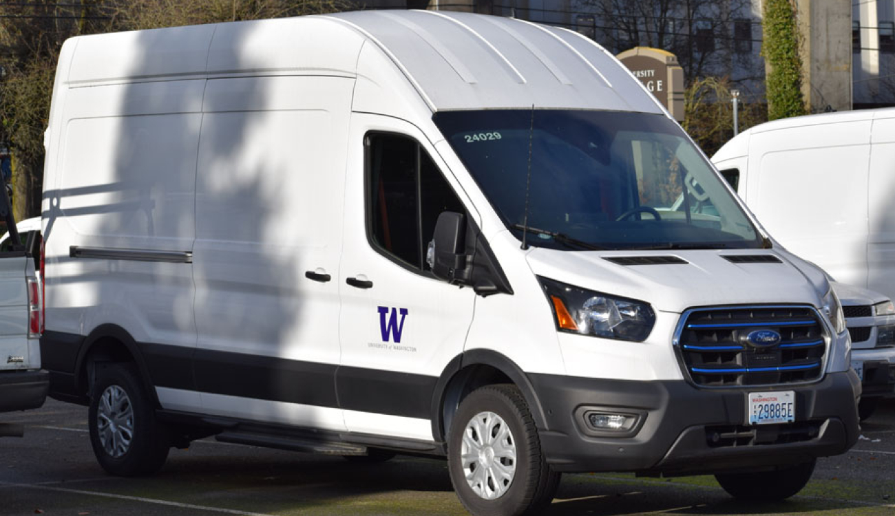 white ford etransit van parked in a lot