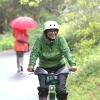 bicyclist biking in the rain along the burke-gilman trail